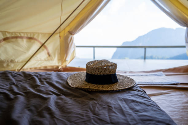 istock Hat is placed on the bed inside the tent, in front of the mountain view. 1385900000