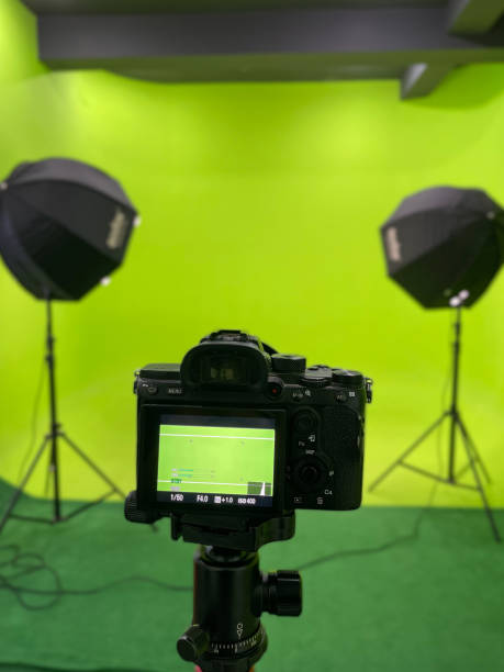 istock Interior of Film Studio with Camera, Green Screen and Light Equipment 1385903046