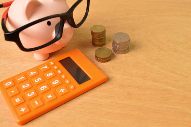 istock Calculator , stack of coins and piggy bank. Copy space. 1385905052