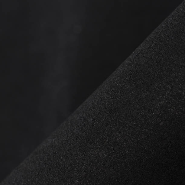istock Black fabric background. Dark natural material. Black durable fabric texture background with copy space for design. 1385905878