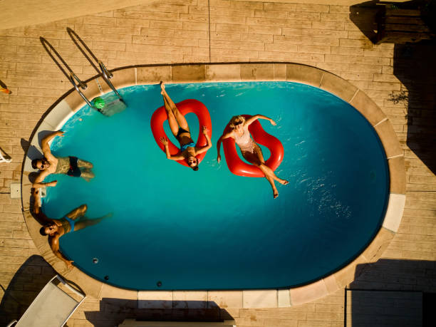 istock Playful friends hanging out at pool party 1385905943