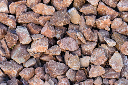 Granite red gravel. A lot of small stones. Creative vintage background.