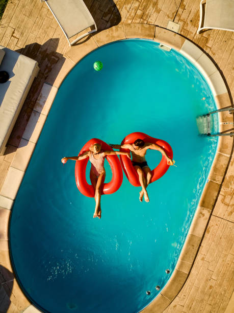 istock Young women relaxing in a swimming pool 1385905963