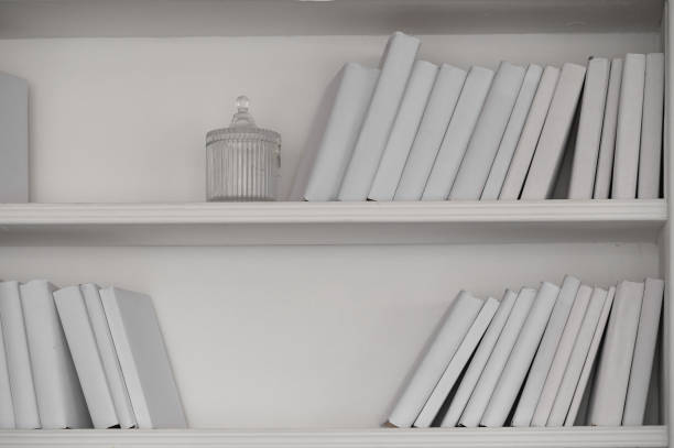 white shelf with books without inscriptions