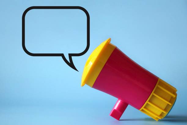 istock Megaphone, loudhailer on blue background with blank speech bubble. 1385907712