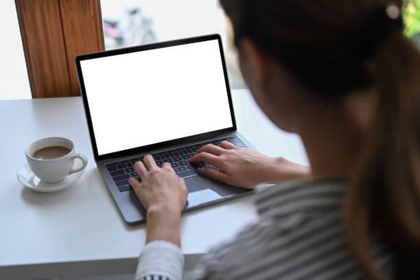 istock Over shoulder business woman checking email on laptop computer. 1385908336