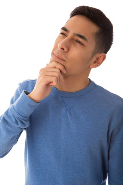 Handsome looking mixed race teenager pensive gesturing on cut out white background