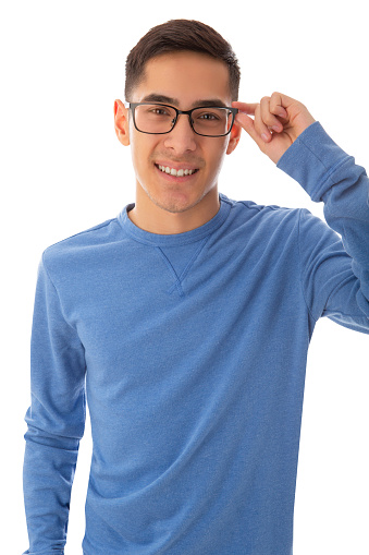 Surprised curly haired guy putting on glasses and staring at camera with open mouth. Handsome bearded young man in blue casual t-shirt posing isolated over white background. Awesome news concept