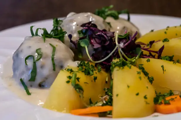 View of Wild garlic Koenigsberger Klopse with potatoes for menu in the restaurant