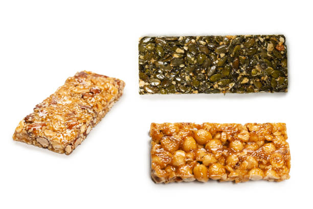 istock Bar with nuts isolated on a white background. Hazelnut bar. 1385917039