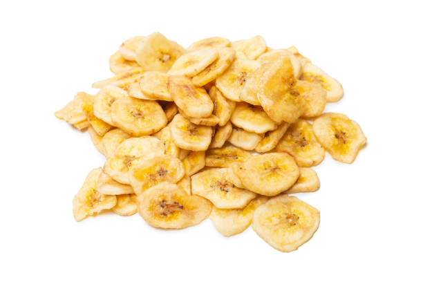 istock Banana chips isolated on a white background. Dehydrated banana. 1385917094