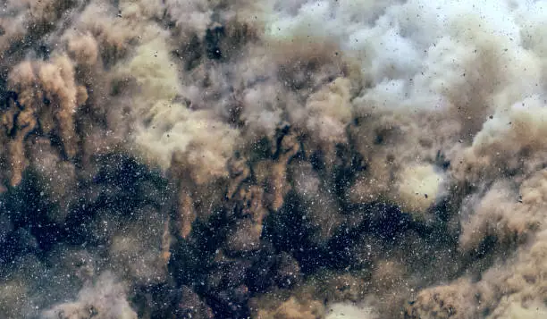 Rock dust clouds after detonator blasting on the construction site in the middle east