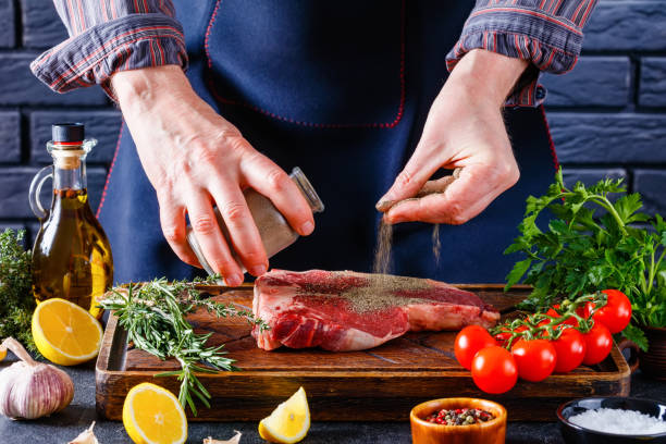istock man cooking beefsteak on a kitchen, close-up 1385919376