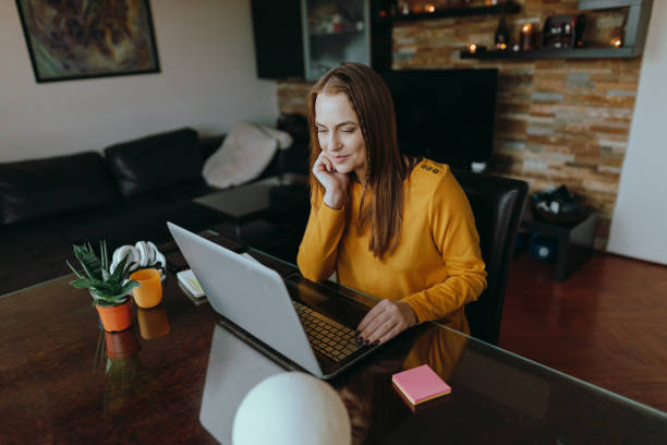istock Woman using a laptop and working from home 1385920163