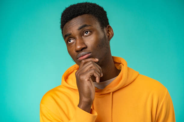 istock Young African American man isolated on mint background thinking and looking up 1385920220