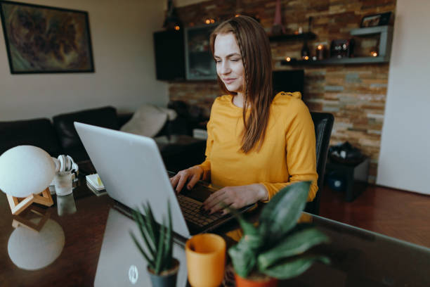 istock Woman using a laptop and working from home 1385920245