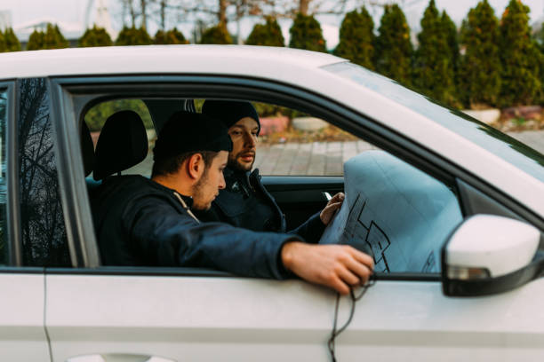 istock Thieves parked in an ally waiting while observing their target and loading their guns. 1385920293