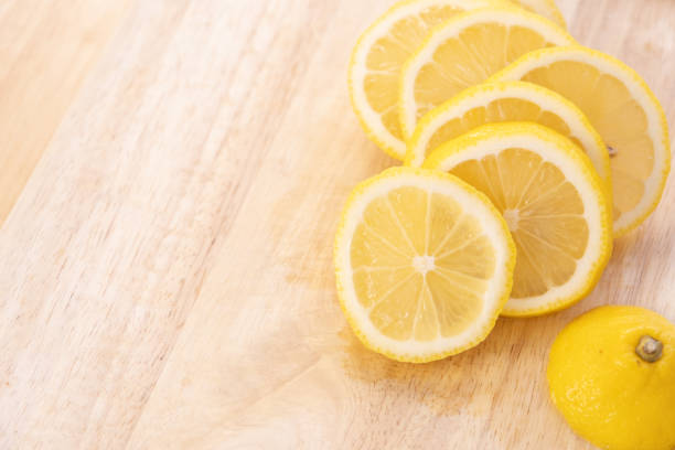 istock Lemon slices on a wooden cutting board 1385921310