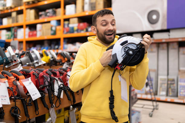 istock satisfied customer holding an electric saw in his hands 1385921470