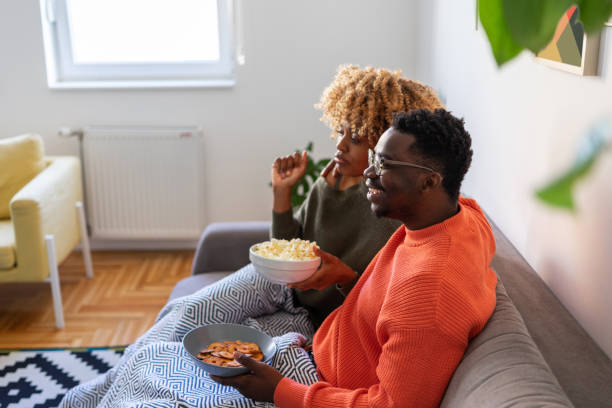 istock The couple is relaxing on the sofa and watching tv 1385922864
