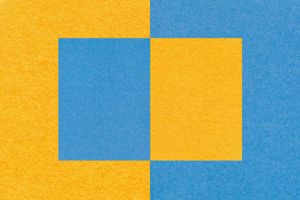 istock Texture of blue and yellow paper background with geometric shape and pattern, macro. Structure of dense craft cardboard. 1385922871