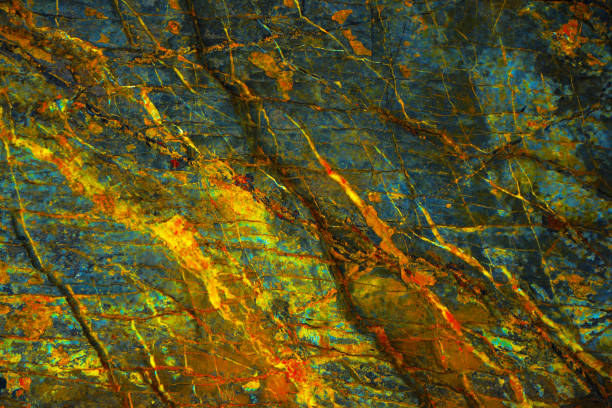 Yellow orange blue abstract grunge background. Toned rock surface texture. Close-up.