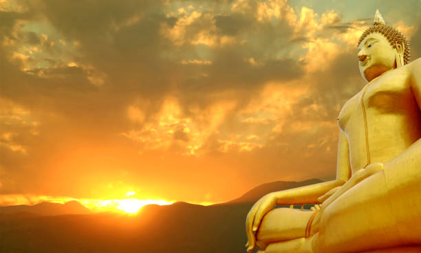 istock Gorgeous Seated Golden Buddha Image with Incredible Sunrise on the Mountain Range 1385926643