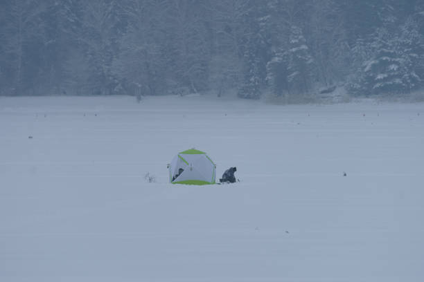 istock Fishermen figurines in winter on the river 1385927007