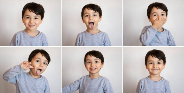 Multiple image of a toddler boy making various facial expressions over white wall stock photo