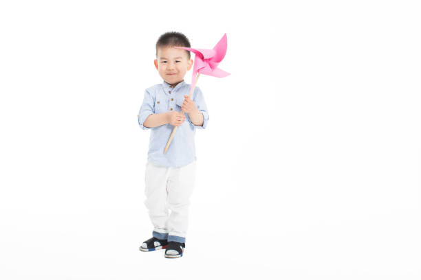 chinese sweet and innocent baby, standing in the studio holding a favorite toy