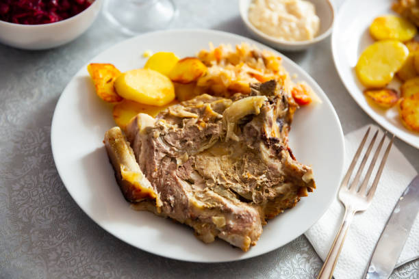 istock Grilled pork meat with roasted potatoes and braised cabbage 1385928168