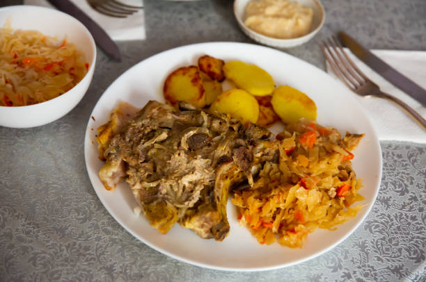 istock Pork meat with roasted potatoes and stewed cabbage 1385928170