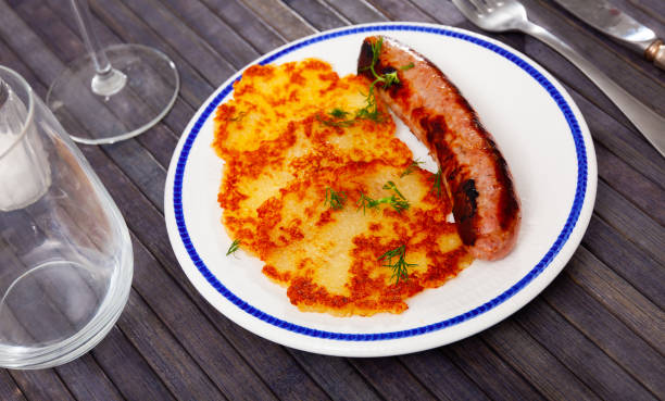 istock Just cooked potato pancakes with roasted sausage on plate 1385928453