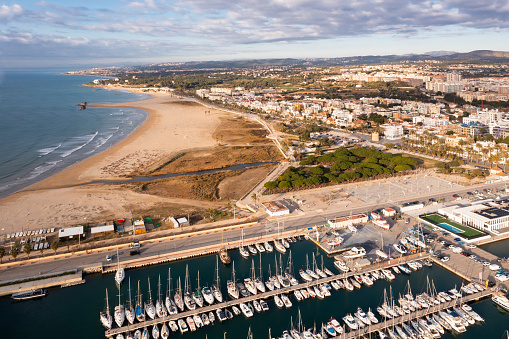 View from drone of Vilanova i la Geltru beach and fishing port with boats at Catalonia, Spain