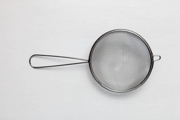 Metal kitchen sieve isolated on white