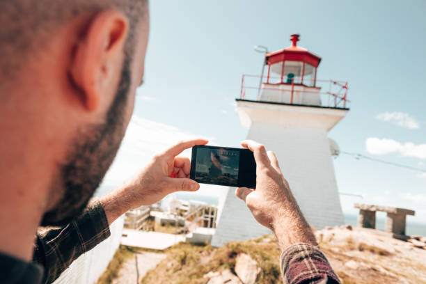istock caucasian man taking a pic in nova scotia 1385930444