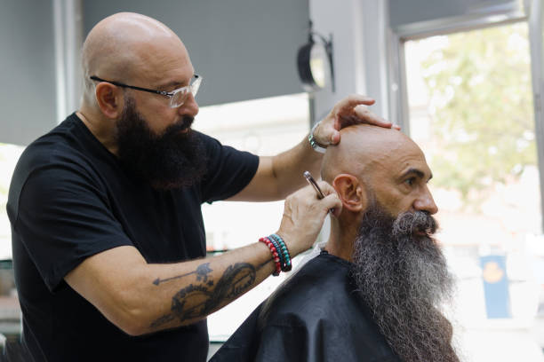 istock barber and client talking gladly during a haircut 1385930551