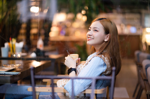 Young Asian business woman working at coffee shop