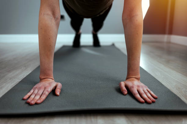 istock Woman doing plank exercise or push ups at home 1385933270