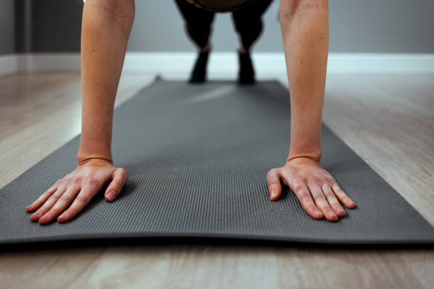 istock Young yogi woman standing in Plank pose. 1385933273