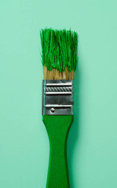 istock paintbrush with green paint 1385934882