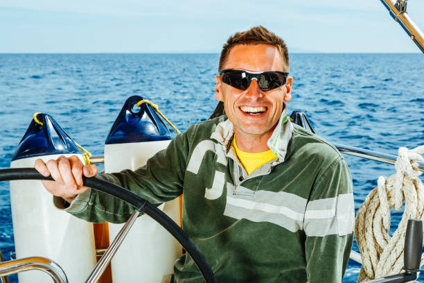 istock Happy skipper on sailboat 1385936108