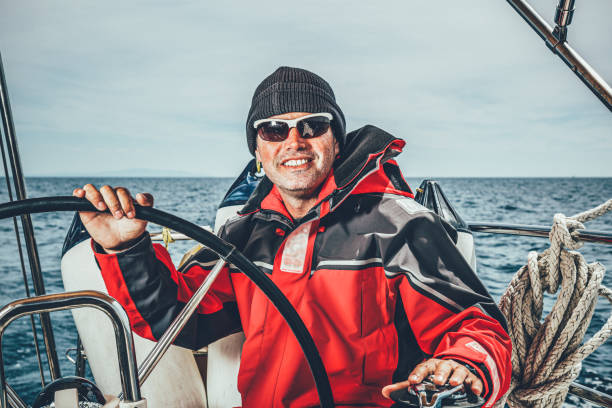 istock Happy skipper on sailboat 1385936160