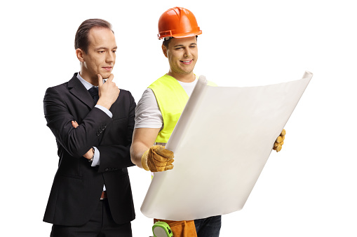 Businessman and a construction site engineer looking at a blueprint isolated on white background