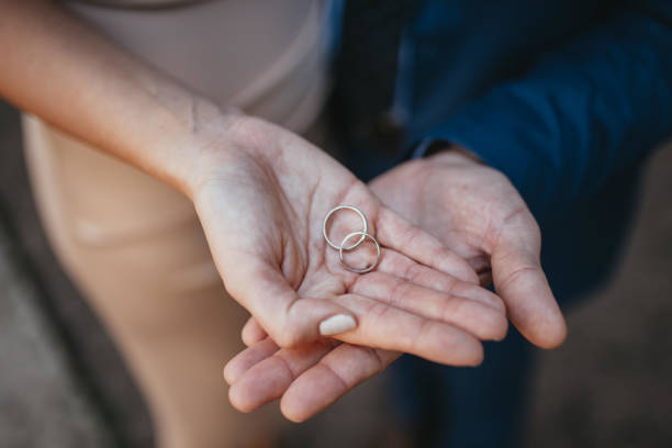 istock Bride and groom with wedding rings. 1385937056