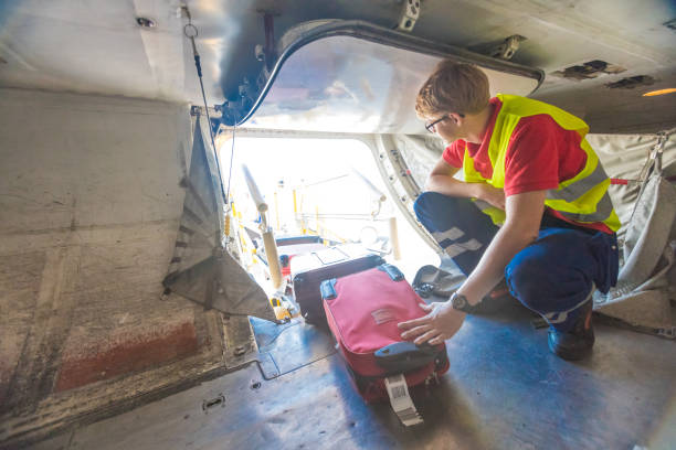 istock Airport service crew unloading luggage 1385937084