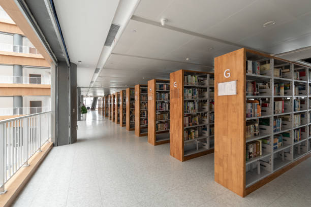 yellow wooden bookcases arranged neatly in the library - library book shelf generic imagens e fotografias de stock