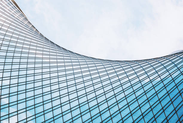 istock Glass building exterior structure, futuristic architecture, wave shape building against sky 1385939912