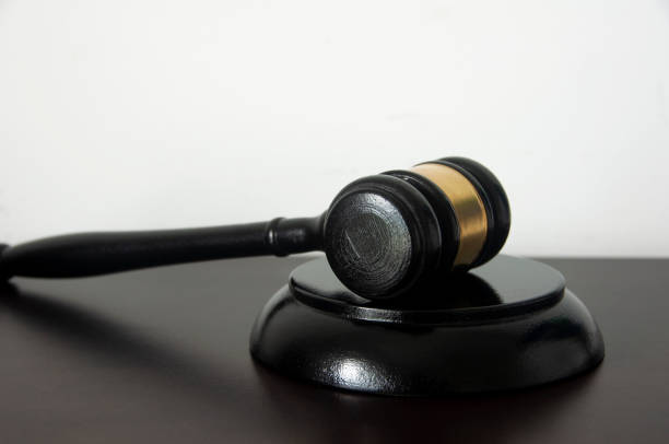 istock Lawyer gavel on wooden table with white background. 1385941810