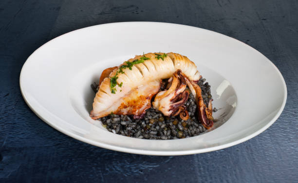 Grilled cuttlefish with black rice stock photo